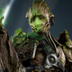 Groot from the new Guardians of the Galaxy game is seen holding some green, glowing spores.